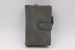 Close-up of grey frosted texture wallet with snap button and golden metal ring