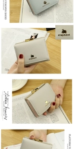 Detail of grey PU leather wallet featuring a gold elephant logo and heart-shaped metal clasp