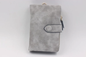 Detail of grey matte women's wallet with vintage suede texture and gold zipper closure