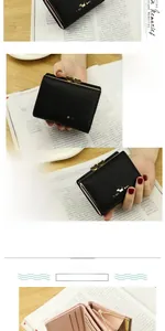 Close-up of a short black tri-fold PU leather wallet with heart-shaped metal clasp and dog logo