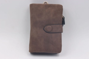 Detail of vintage brown frosted wallet with snap closure and gold D-ring hardware