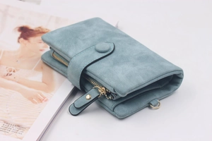 Detail view of light blue frosted matte wallet with gold zipper and multi-card slots