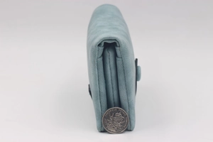 Side view of matte sky blue tri-fold wallet showing thick multi-layer card slot structure