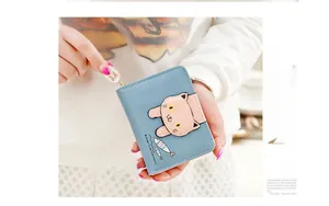 Detail of light blue mini wallet featuring a cute cartoon cat patch and fish print details