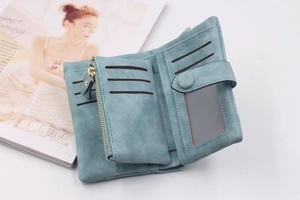 Detail view of the light blue matte tri-fold wallet showing multiple card slots and coin pouch