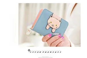 Close-up of a short blue PU leather wallet featuring a cute cartoon cat and fish patch