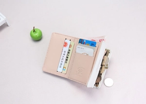 Detail view of pink trifold wallet interior with multiple card slots and cash compartment