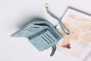 Detail view of the trifold wallet's interior slots, zipper pocket and wrist strap