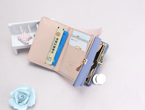 Detail view of tri-fold wallet interior with multiple card slots and metal coin compartment