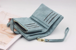 Detail view of light blue frosted tri-fold wallet with card slots and gold zipper