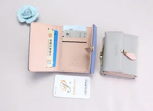 Detail view of tri-fold PU leather wallet with leaf pendant and multi-card slots