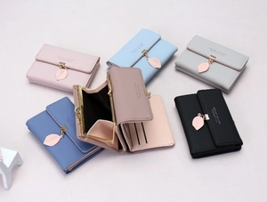 Short tri-fold wallet detail featuring leaf pendant, card slots, and kiss-lock coin pocket