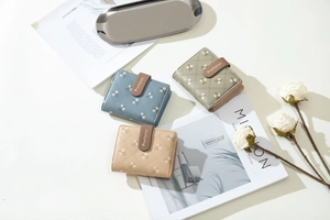 Flat lay of quilted PU leather wallets with floral print and metal zipper pocket