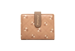 Close-up of pink PU leather wallet with quilted pattern and white floral prints