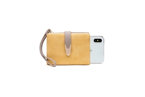 Detail view of mustard yellow frosted leather wallet with wristlet and phone for scale