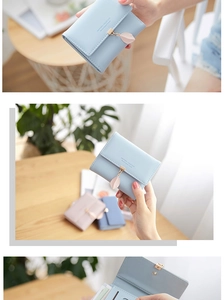 Detail view of the light blue leaf-pendant wallet and its functional internal card slots