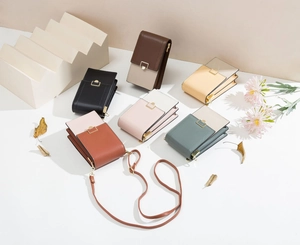 Multiple colorful PU leather mini crossbody phone bags with adjustable straps and gold buckles