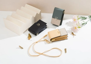 Detailed view of fashionable mini PU leather phone bags with metal buckle on white steps
