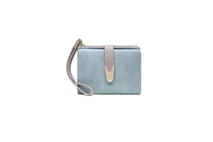 Detailed macro view of the light blue suede texture with golden buckle and zipper puller