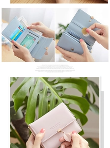 Detail view of tri-fold wallet interior featuring multiple card slots and leaf zipper charm