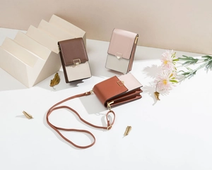 Detailed view of color-block PU leather vertical crossbody phone bags with metal clasps