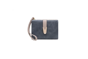 Close-up of matte dark blue women's short wallet with decorative buckle and wrist strap