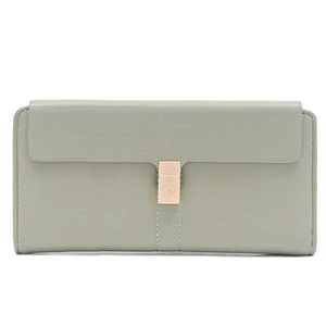 Close-up of sage green leather texture and light gold heart-shaped buckle on long wallet