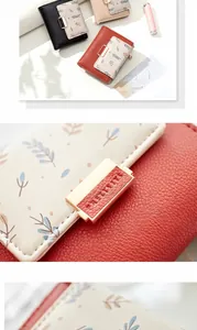 Detail of multi-color floral leather wallets featuring elegant golden metal snap closures