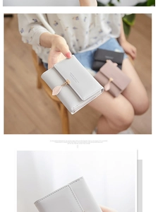 Detailed view of women's short PU leather wallets featuring elegant leaf pendant charms