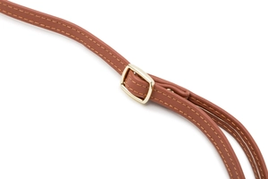 Close-up of brown PU leather shoulder strap with gold buckle and reinforced stitching