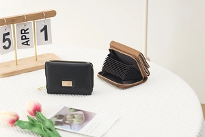 Detail view of multi-slot accordion card wallet in black and brown PU leather