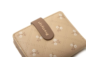 Close-up of beige PU leather wallet with floral print and diamond stitched pattern