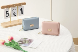 Short PU leather accordion wallets in light blue and pink with floral metal badge detail