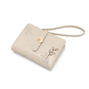 Close-up of beige PU leather wallet featuring exquisite leaf embroidery and gold floral snap