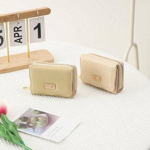 Close-up of compact PU leather wallets with elegant metal plaque and zipper closure