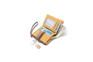 Macro detail of mustard yellow matte wallet showing multiple card slots and wrist strap