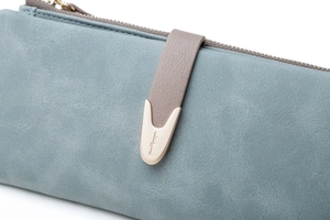 Detail of blue matte PU leather wallet with golden teardrop buckle and smooth metal zipper