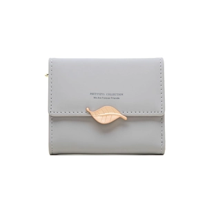 Close-up of light grey faux leather wallet featuring a rose gold leaf buckle and stitching