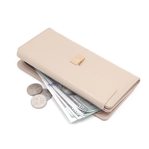 Detailed view of beige long wallet featuring heart buckle and spacious coin compartment
