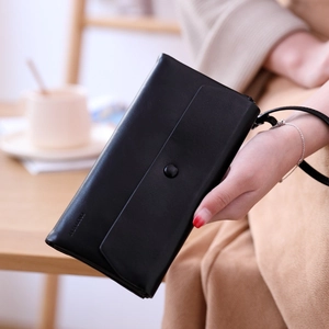 Close-up of black PU leather long wallet with envelope flap and wristlet strap detail