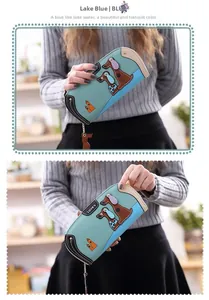 Detail of lake blue long wallet featuring embroidered dachshund dogs and heart buckle