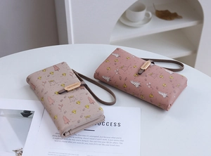 Detail of Korean style long wallets with forest illustrations and metal buckles