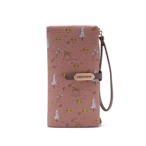 Detailed close-up of pink leather wallet featuring forest illustration and metal buckle