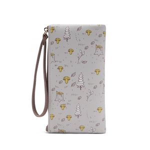 Detail view of the forest pattern and wristlet strap on a grey faux leather long wallet