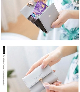 Close-up of a grey tri-fold card holder with leaf zipper and accordion slots