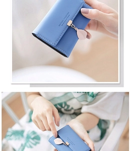 Detail of blue PU leather card holder featuring a leaf pendant and snap buckle closure