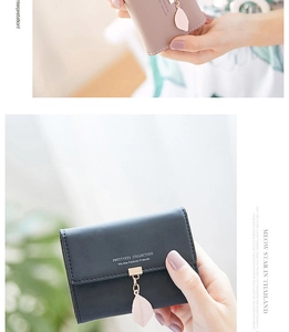 Detail of PU leather tri-fold wallets with button closure and metal leaf pendant