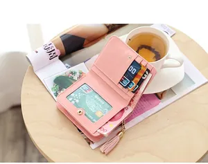 Detail of pink PU leather long wallet showing multi-card slots and tassel charm