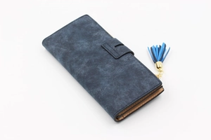 Detail of matte blue long wallet featuring metal clasp and dual-tone tassel accessory