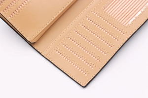 Detail of the interior card slots and striped photo ID holder in a tan leather wallet